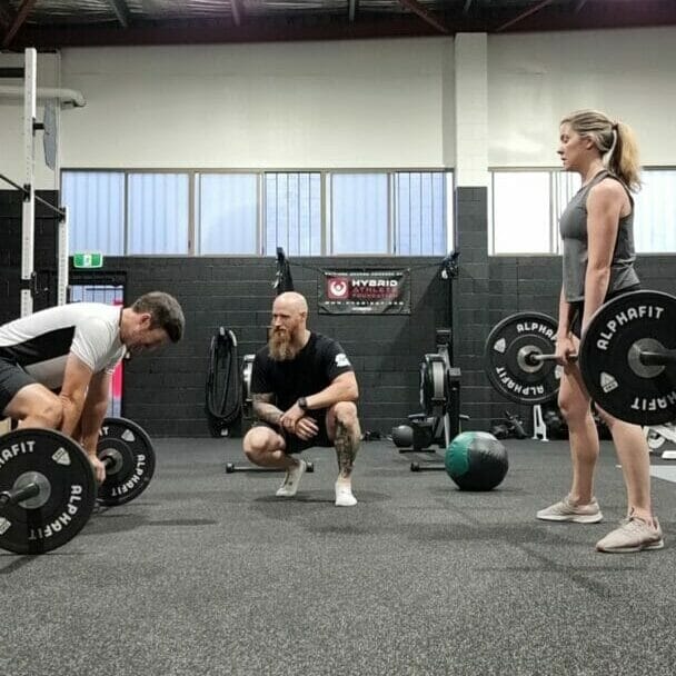 Coaching at Limitless Performance Centre. two people being coached. Deadlifts. Couples workout.